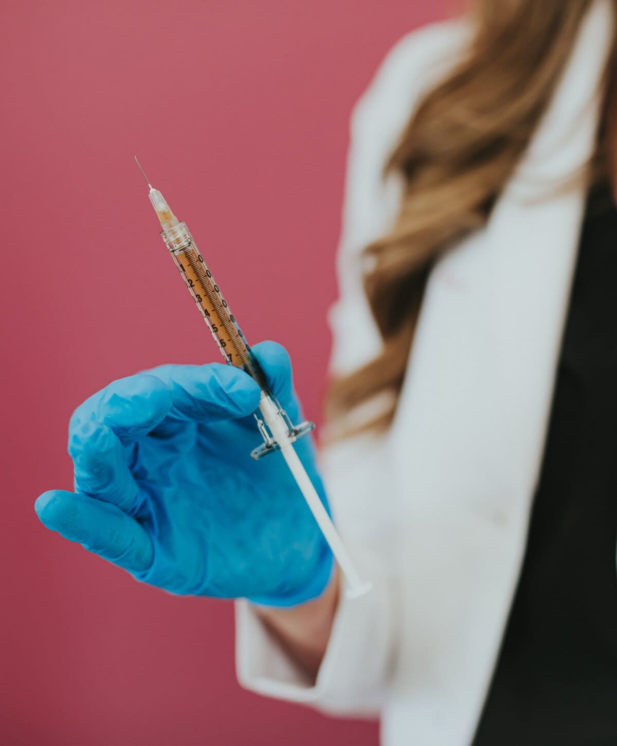 Woman holding full syringe