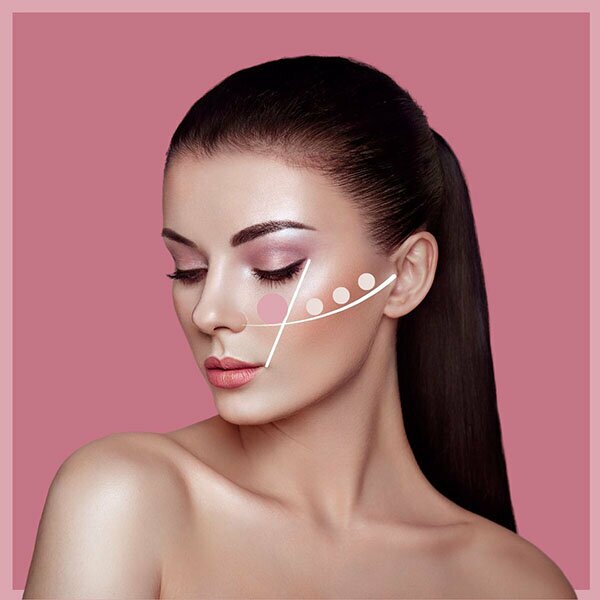 Beautiful woman with graphic over cheek showing cheekbone contour
